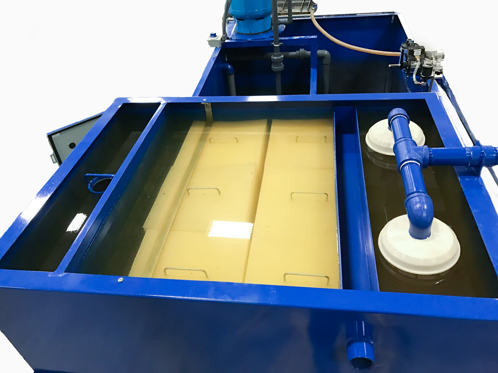 Open coolant recycling system showing tanks and fluid-processing equipment